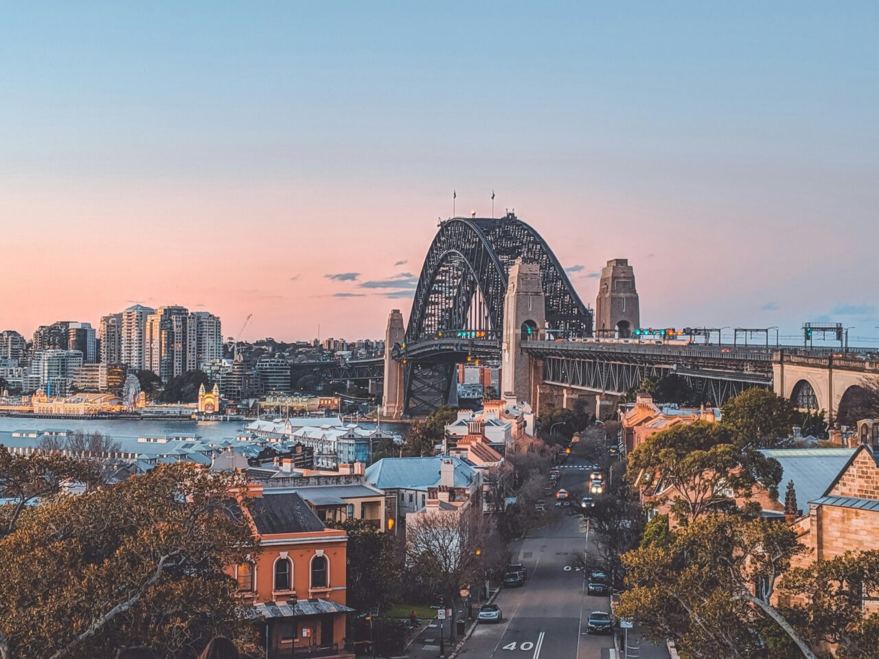 Sydney harbor bridge against a pink sky